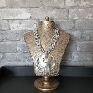 White beaded necklace with shell pendant